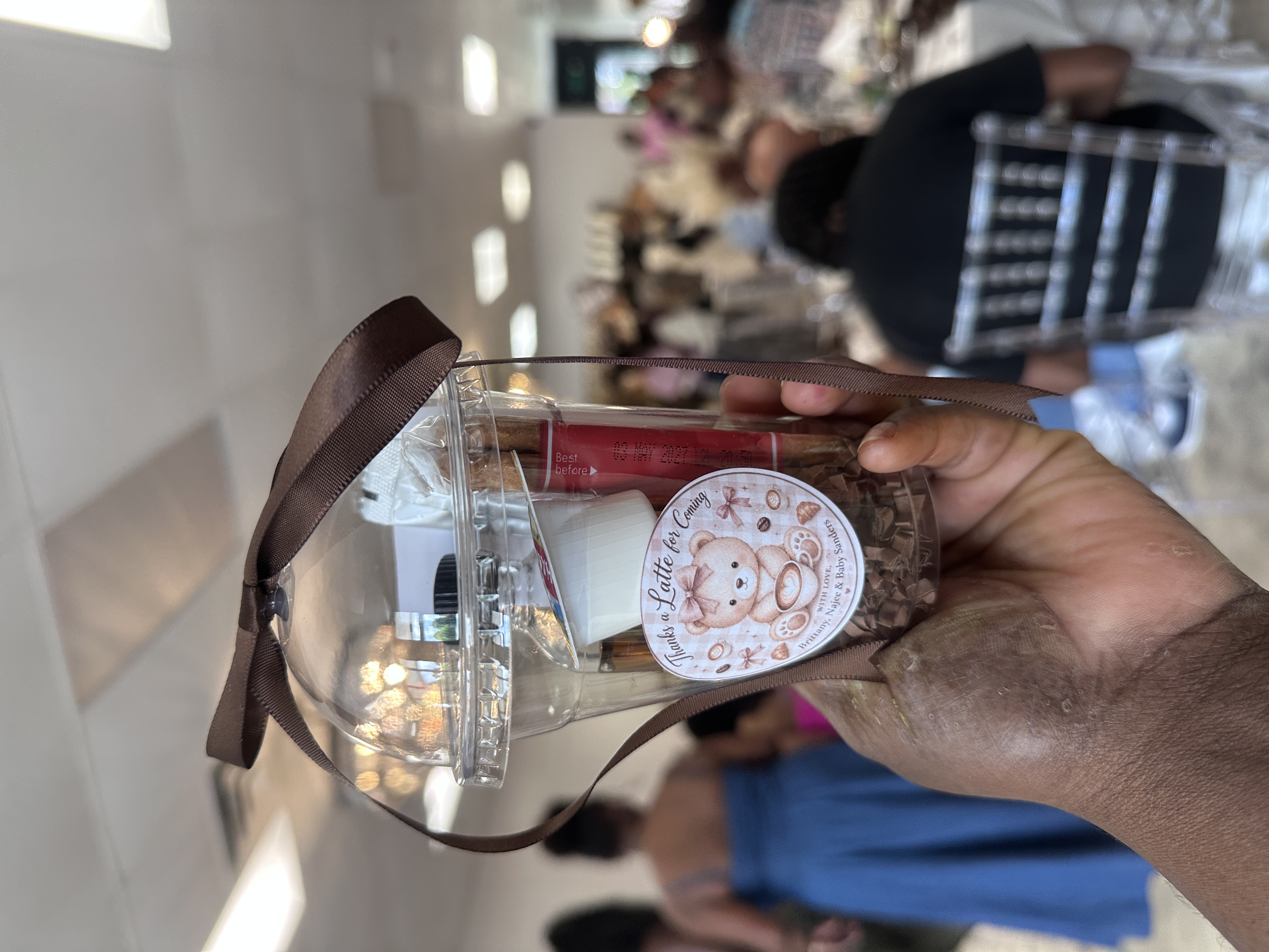 Thanks a Latte for Coming custom baby shower favor cup with brown ribbon at Atlanta coffee-themed baby shower catered by Tee Coffee Studio