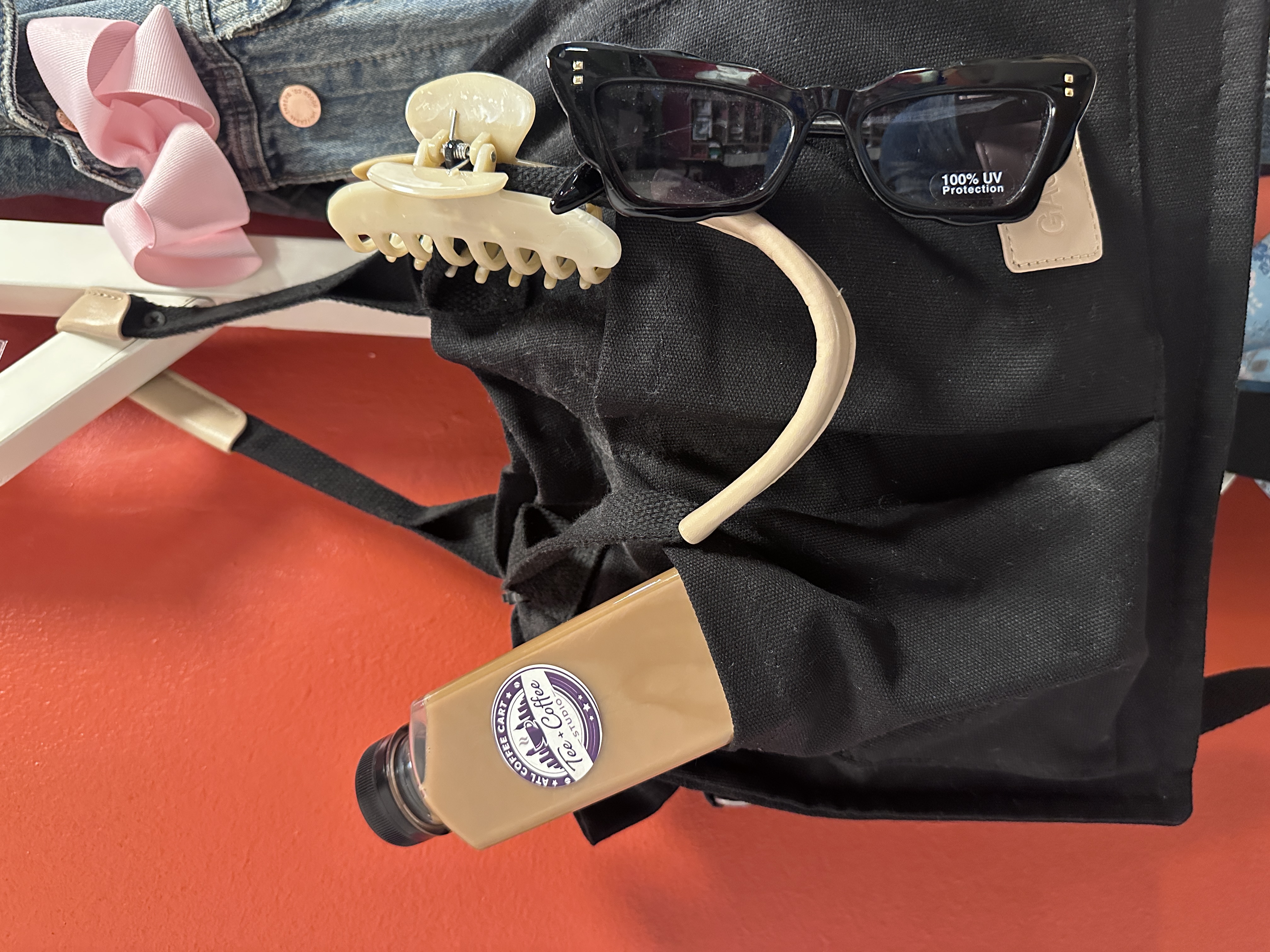 Tee Coffee Studio branded bottled latte tucked into a stylish tote bag at Atlanta pop-up