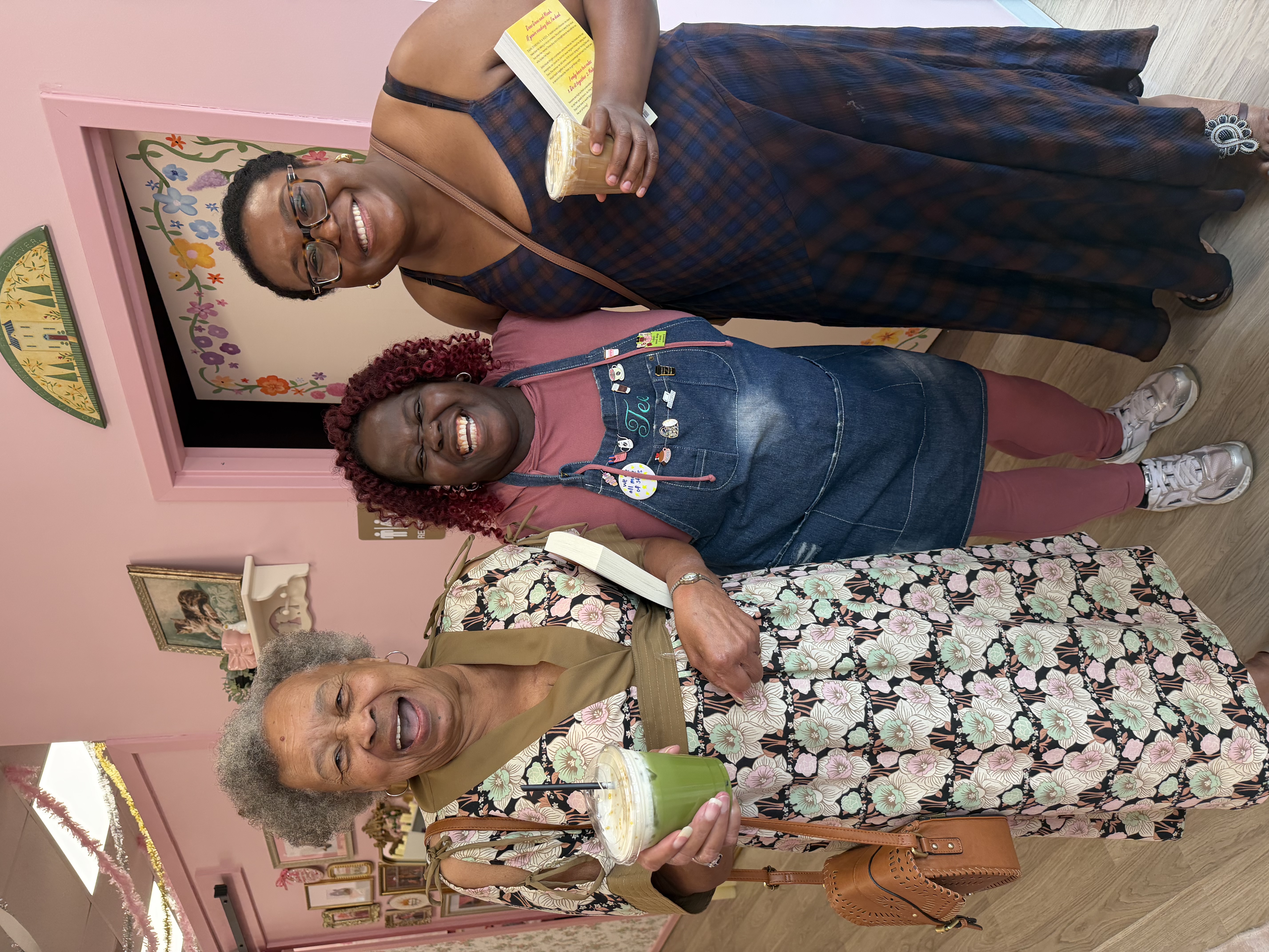 Tee George laughing with guests at Atlanta community event holding specialty matcha and latte drinks