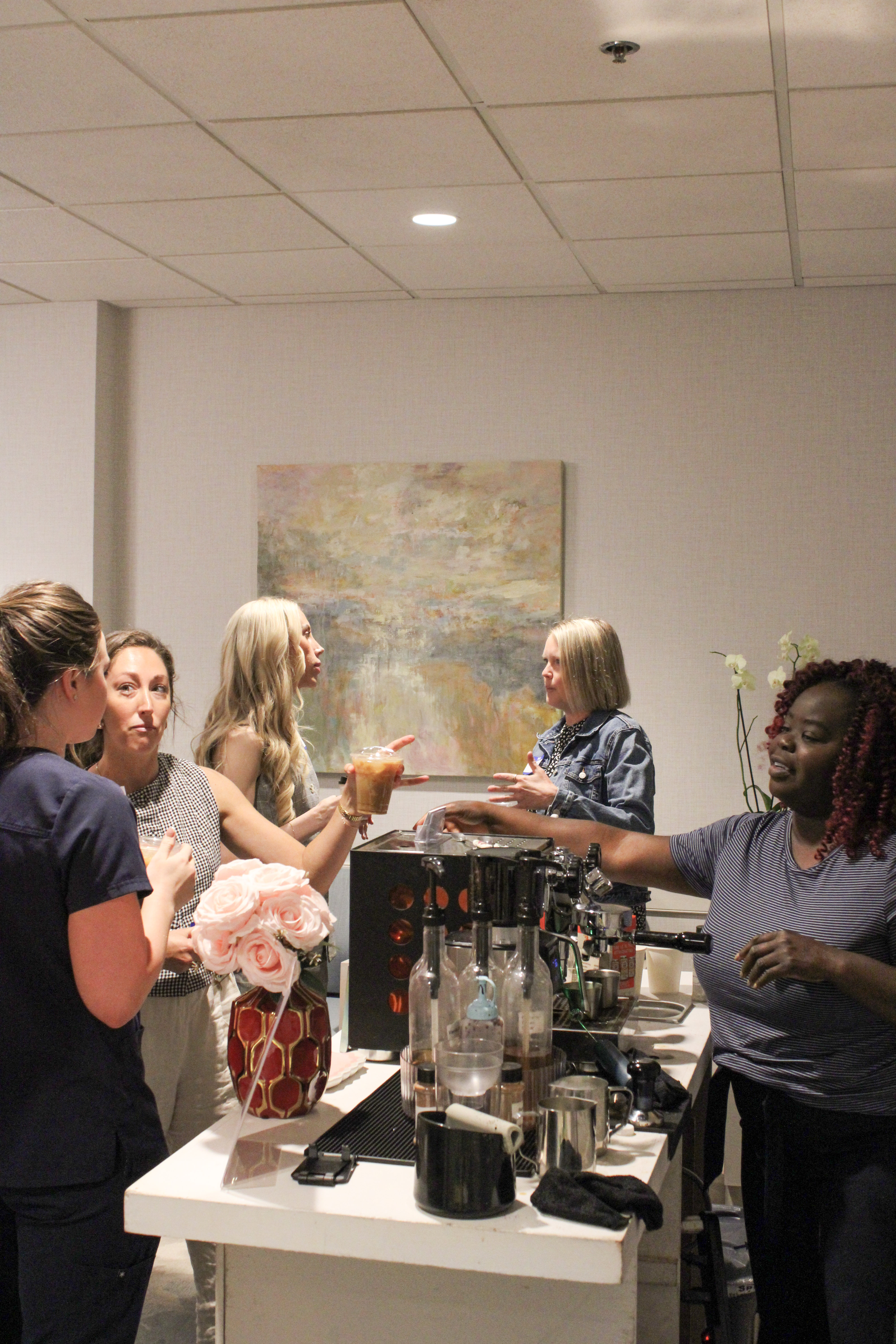 Atlanta office team gathered around the Tee Coffee Studio espresso bar