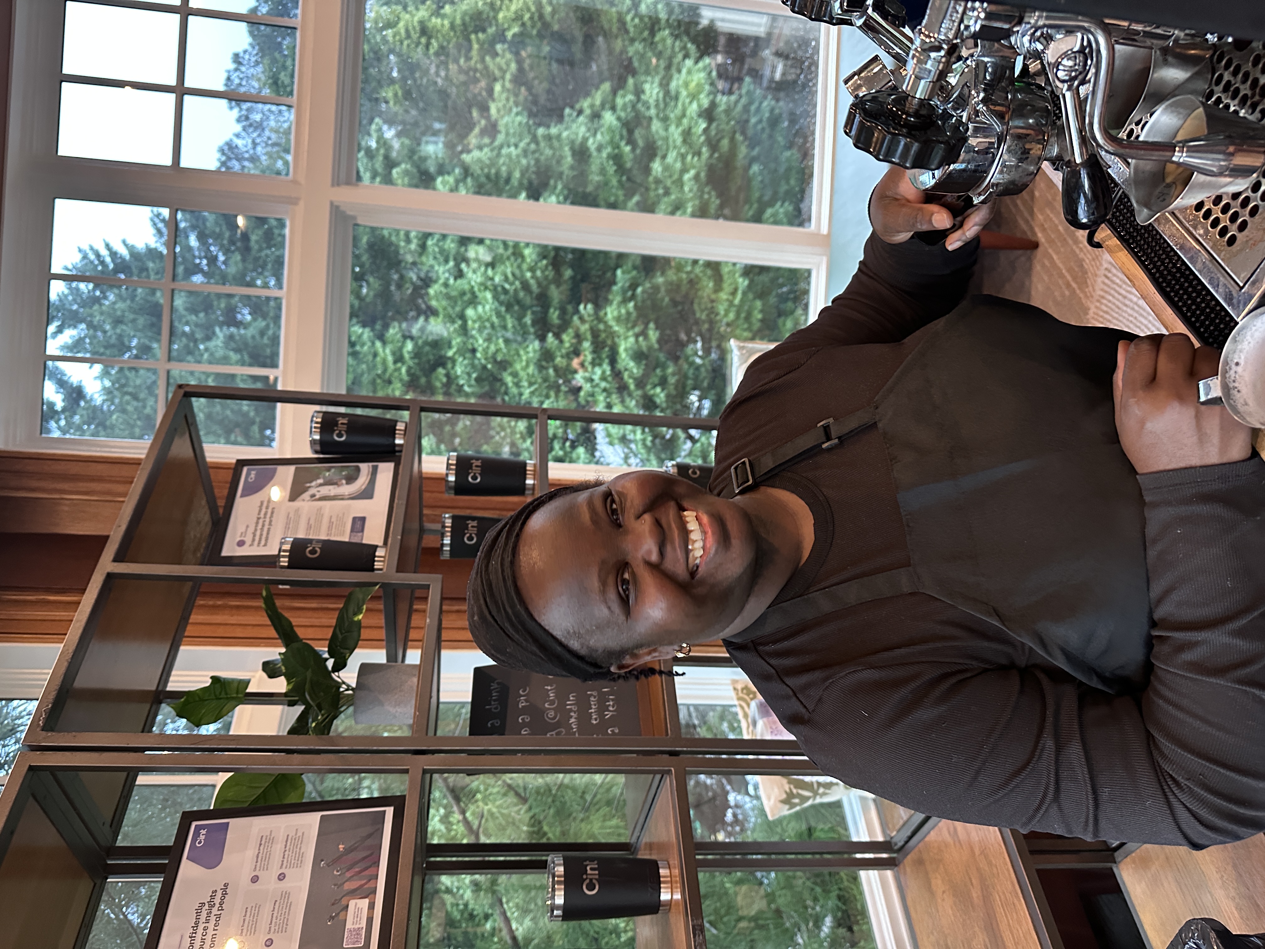 Tee George operating commercial espresso machine portafilter at Atlanta corporate catering event