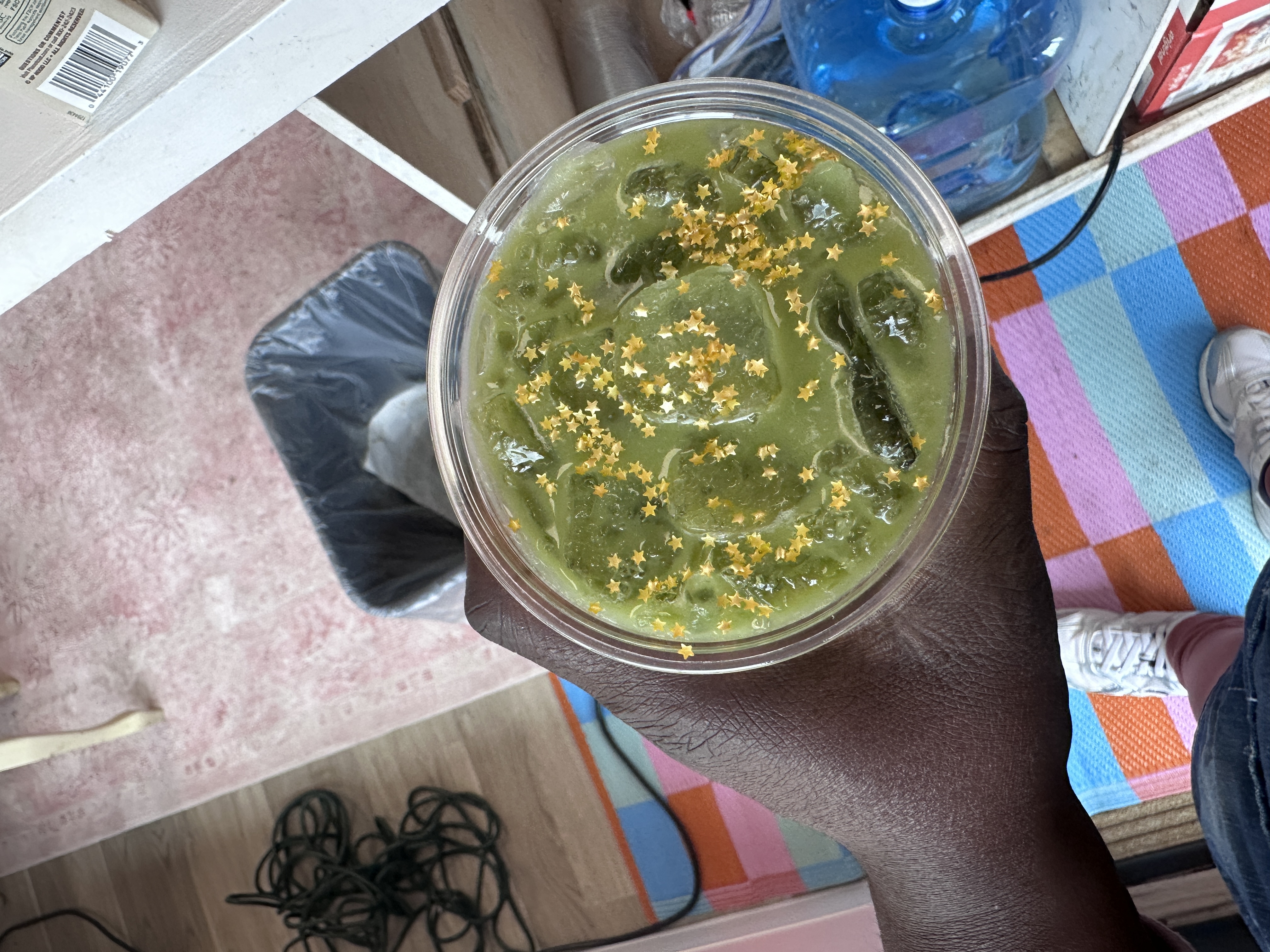 Tee Coffee Studio specialty iced matcha latte with gold star sprinkles at Atlanta event