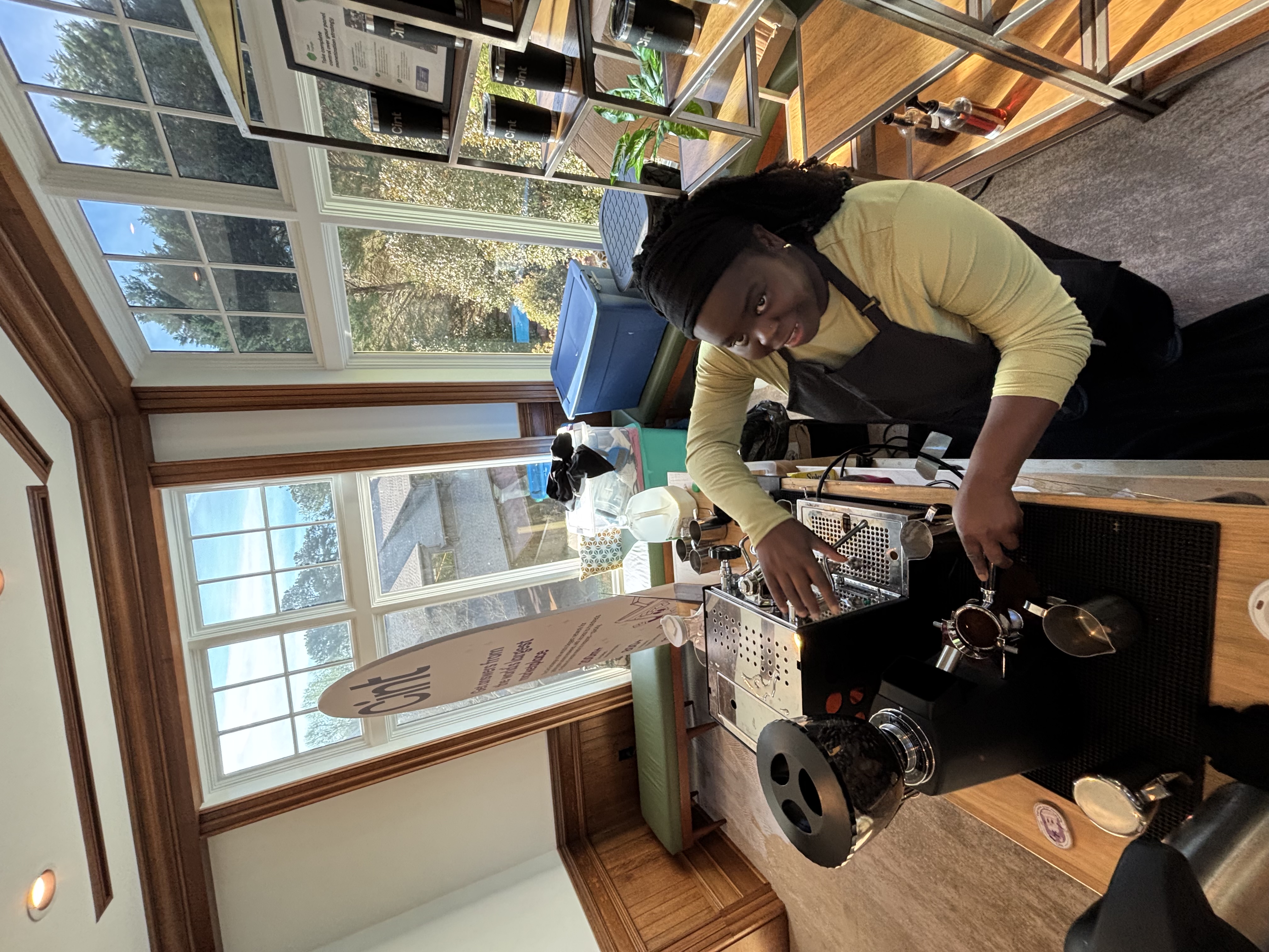 Overhead angle of Tee George working commercial espresso setup at Atlanta corporate conference in elegant venue