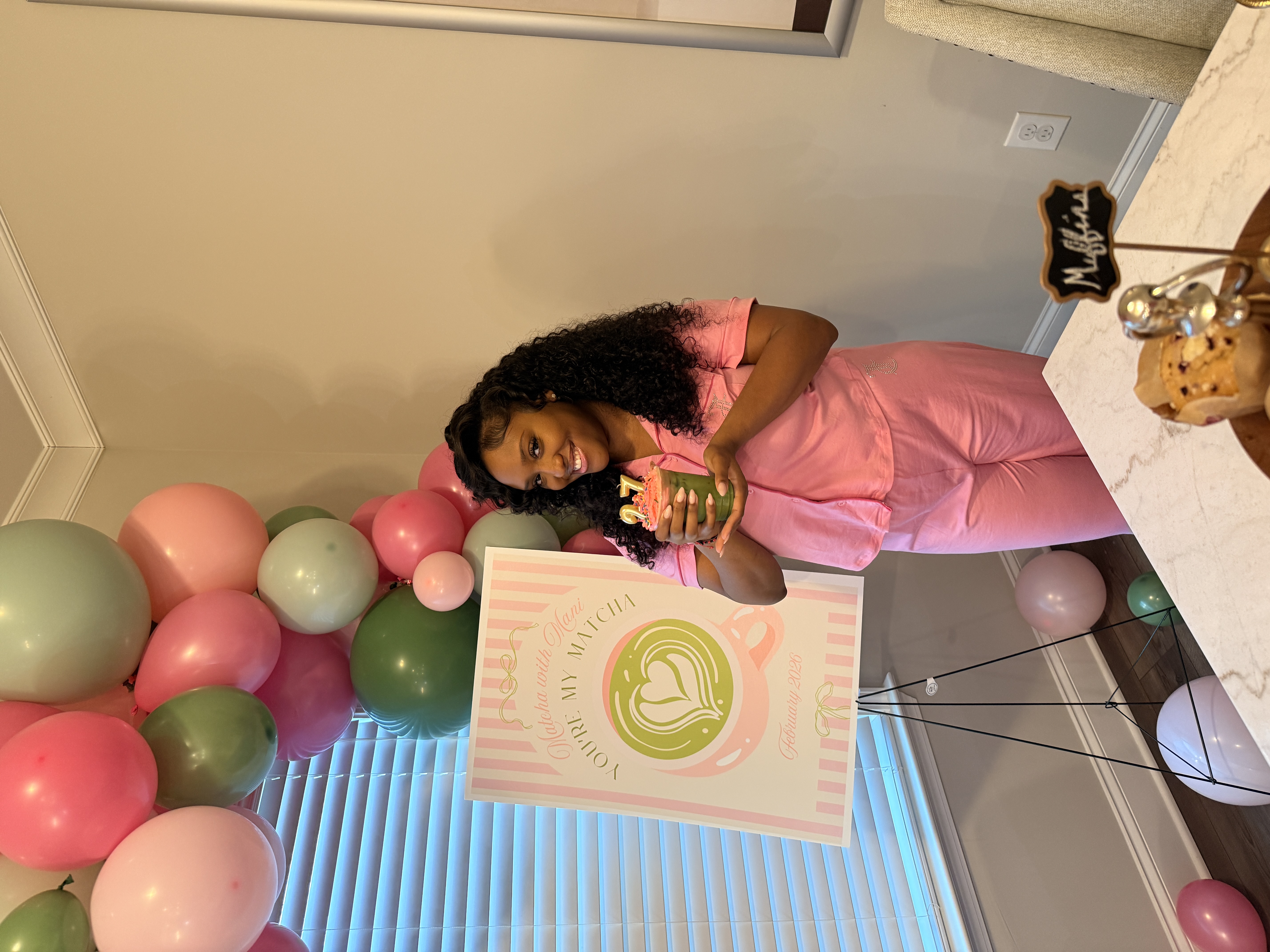Birthday guest holding matcha drink next to You're My Matcha event sign at Atlanta birthday party
