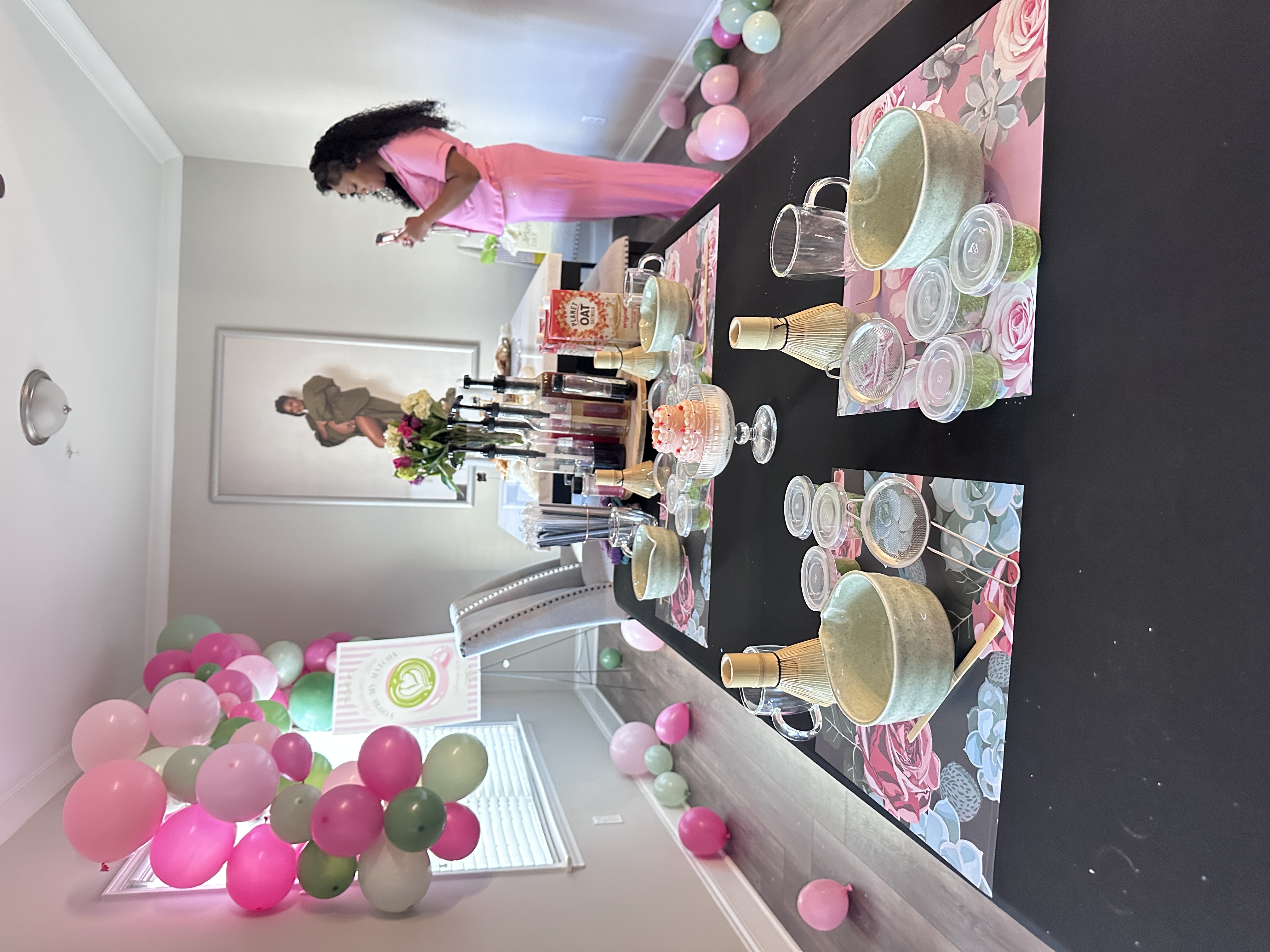 Full room view of Tee Coffee Studio matcha experience setup with balloon garland and station table