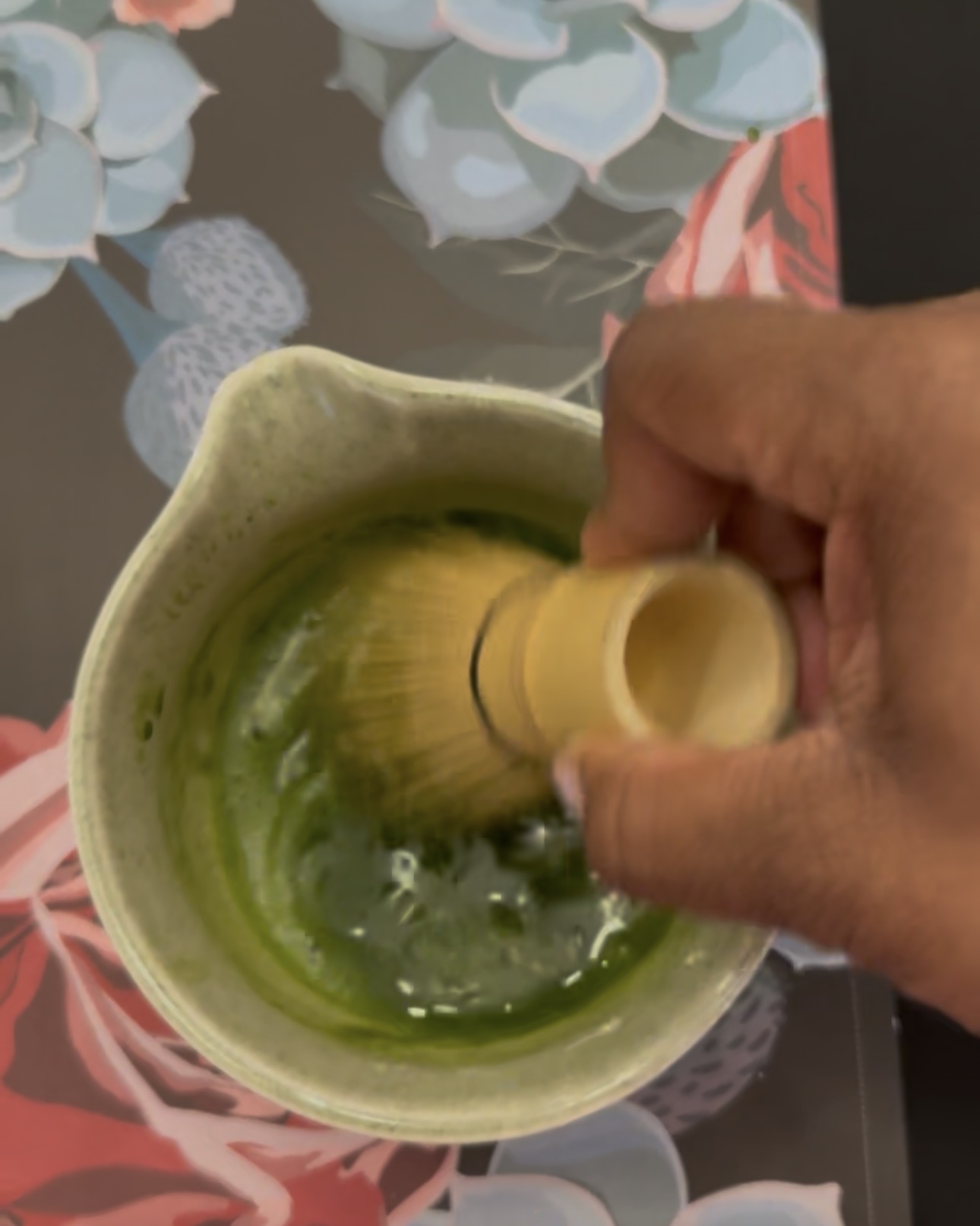 Tee of Tee Coffee Studio smiling while whisking ceremonial matcha in Atlanta home