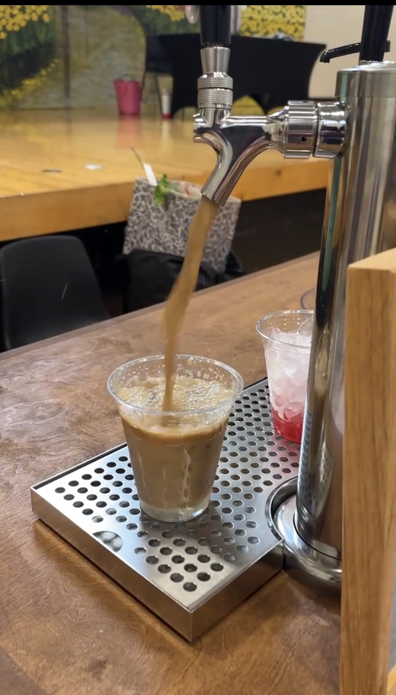 Cold brew pouring from tap into cup at a Tee Coffee Studio tap cart event in Atlanta