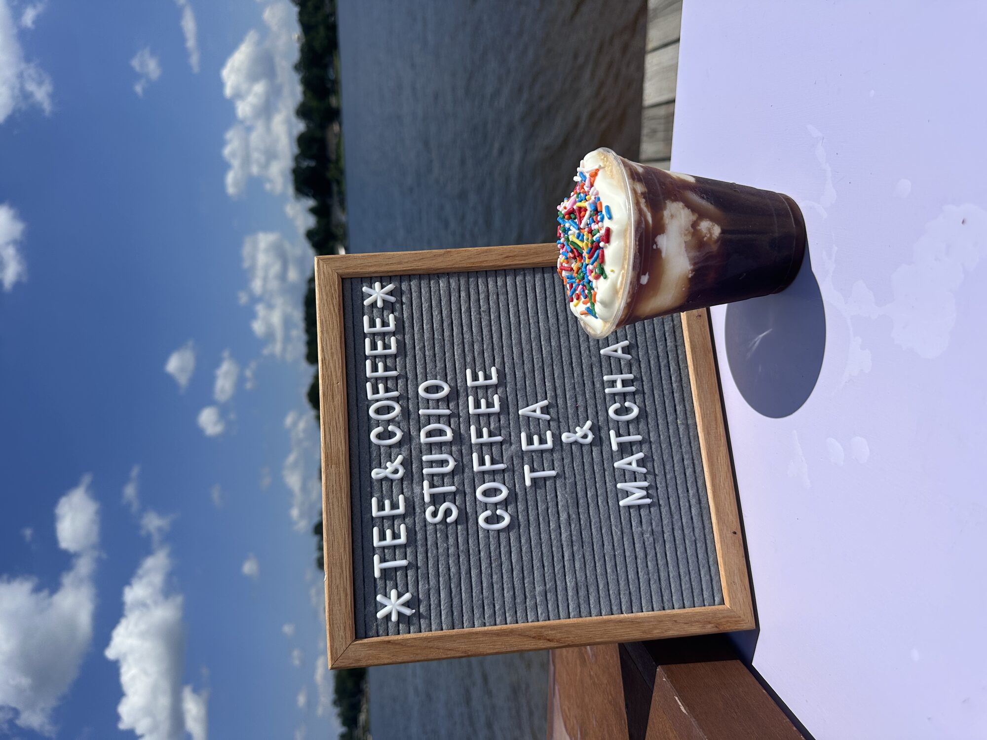 Iced hot chocolate topped with whipped cream and sprinkles from the Tee Coffee Studio tap cart
