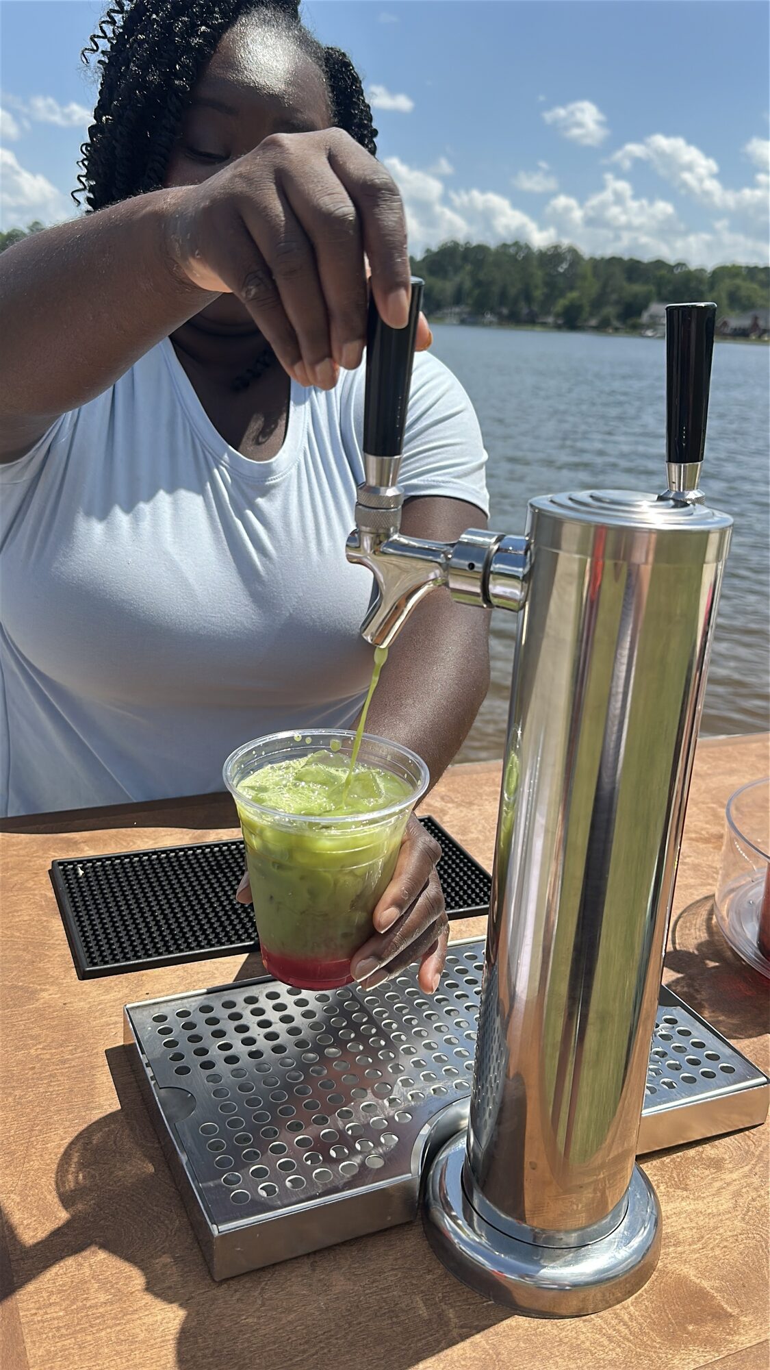 Matcha pouring from tap at a Tee Coffee Studio lakeside event in Atlanta