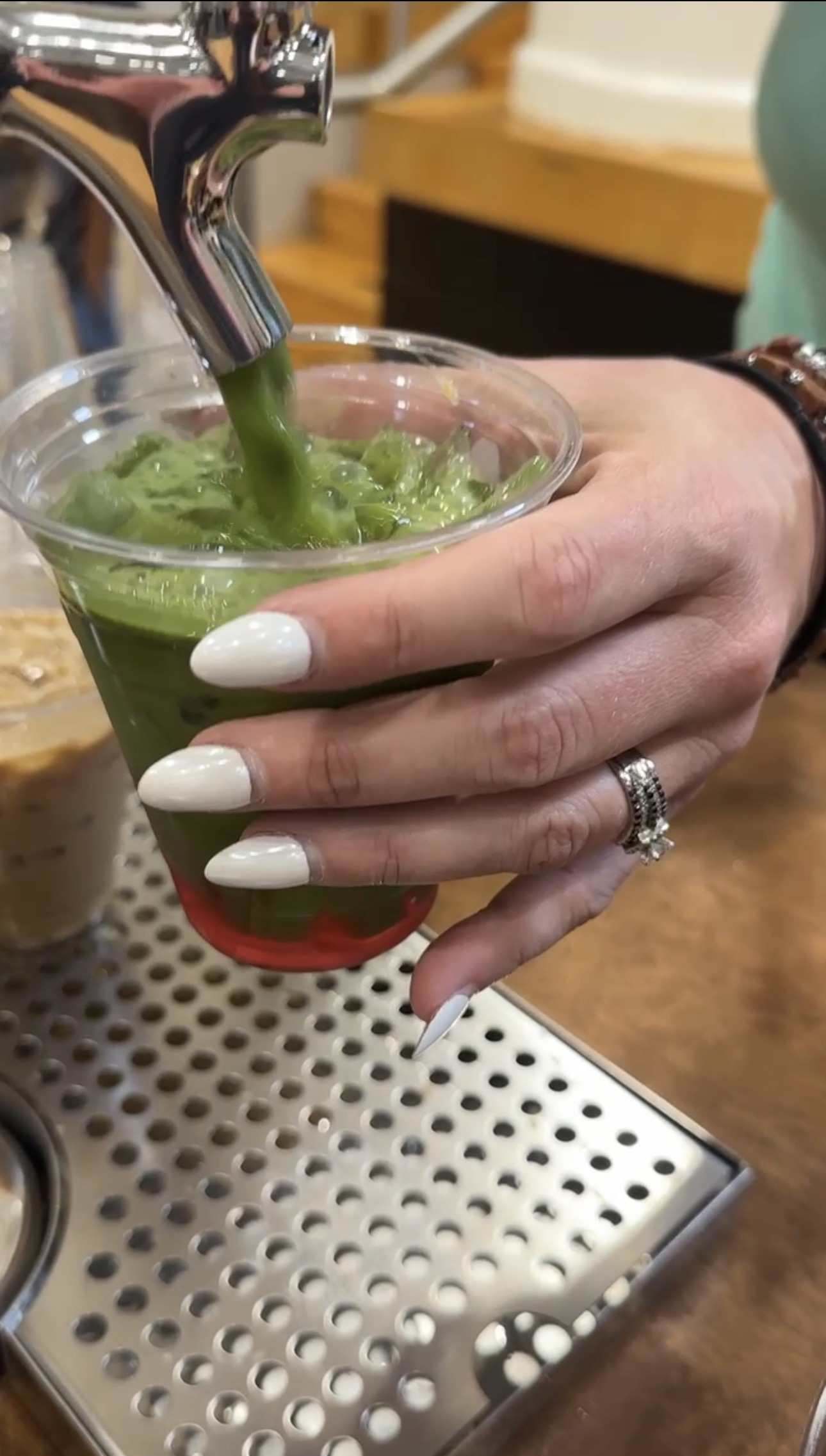 Close up of matcha pouring from the Tee Coffee Studio tap cart