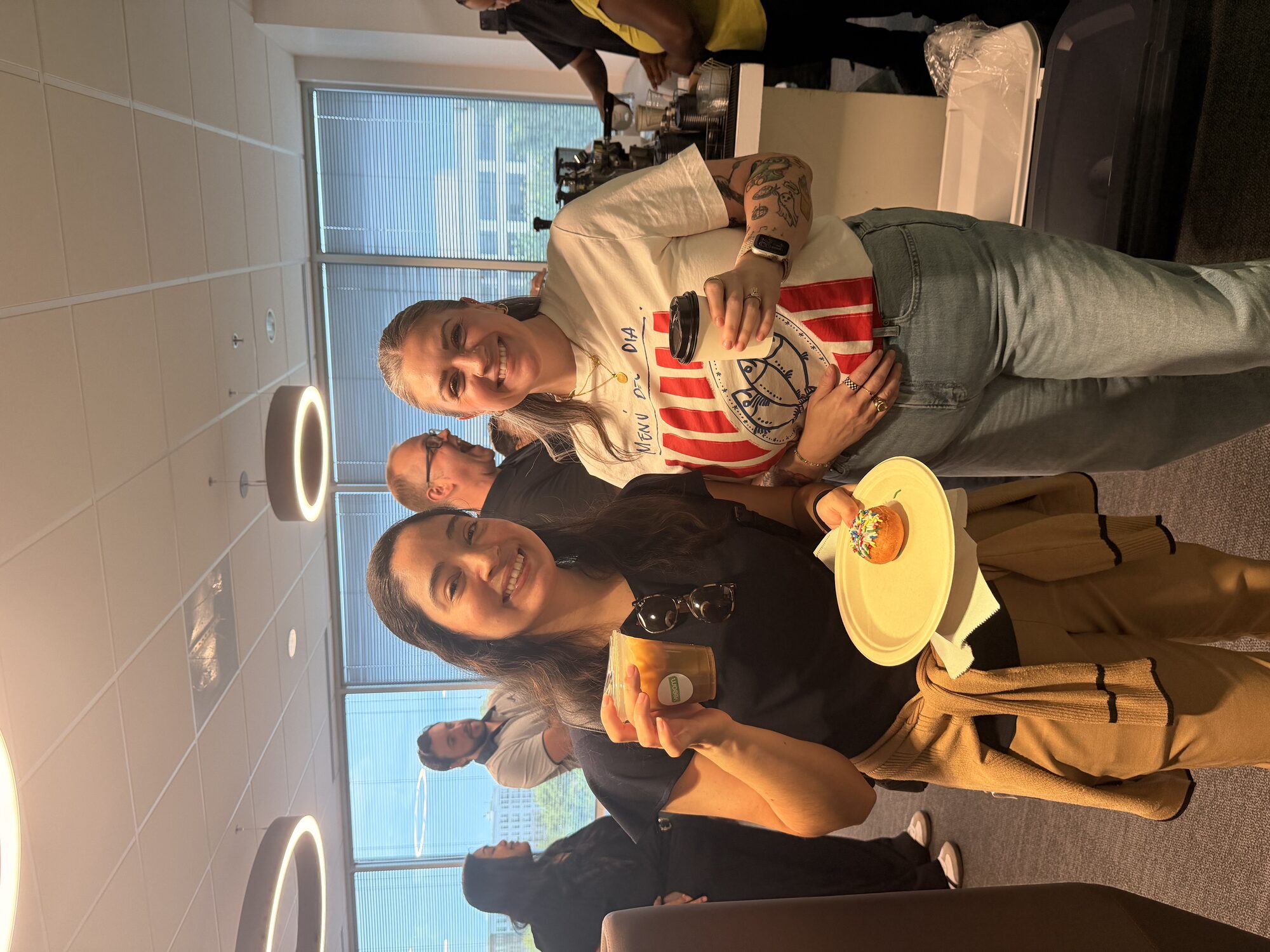 Corporate guests enjoying iced lattes and pastries at a Tee Coffee Studio office coffee event